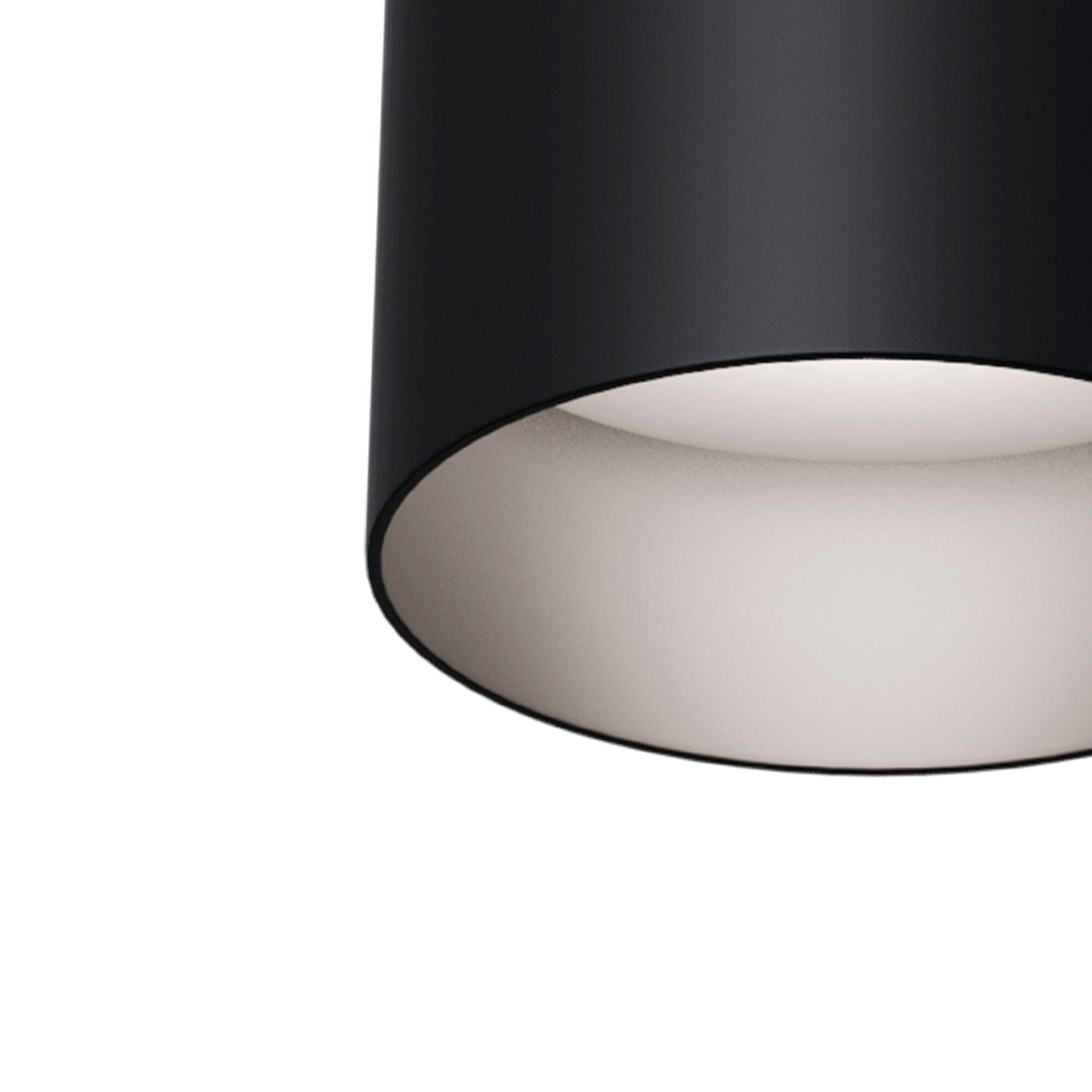 A close-up of the Slim Round Surface Mounted Downlight - Black shows its black cylindrical design with a white interior for soft diffusion, embodying modern minimalistic lighting and fitting a GU10 bulb for efficient illumination.