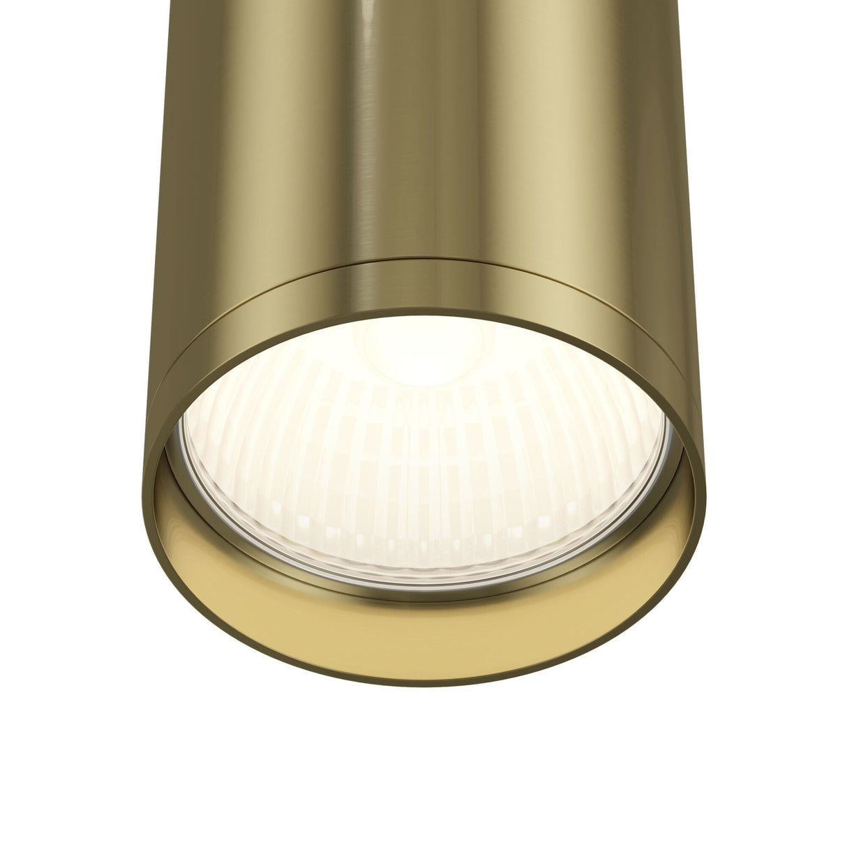 The Focus S Fixed Round Surface Mounted Downlight in brass features a cylindrical form with a glowing LED bulb. Its slightly textured interior finish enhances luxury interior design, offering a warm and elegant look.