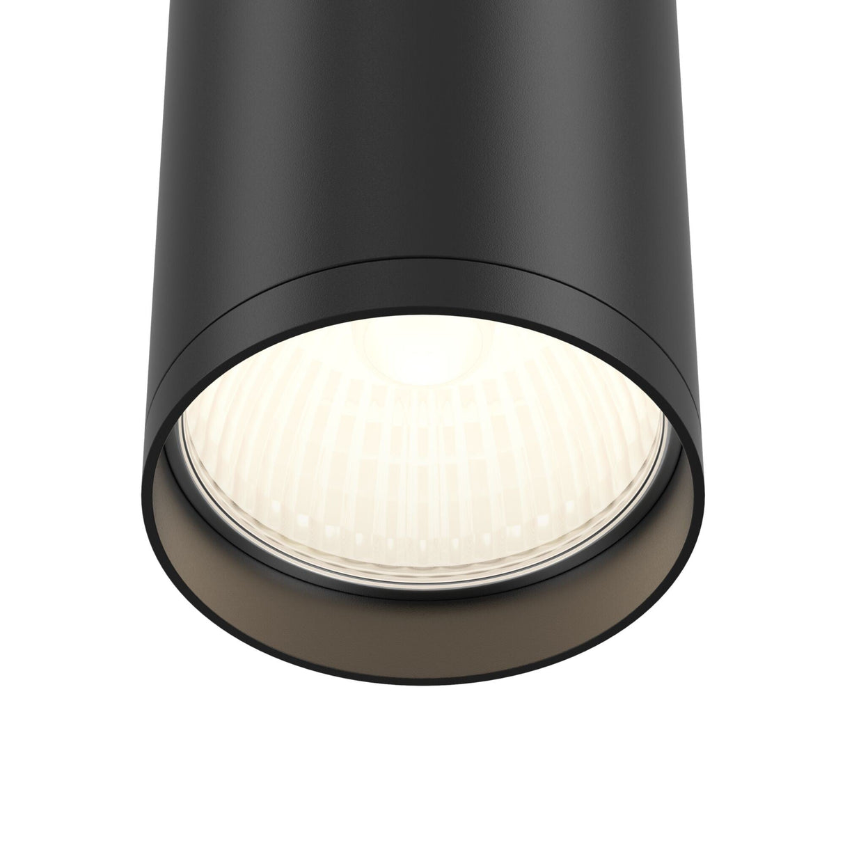 Close-up of the Focus S Fixed Round Surface Mounted Downlight - Black, featuring a glowing bulb and intricate textured pattern around the inner rim, epitomizing an industrial style.