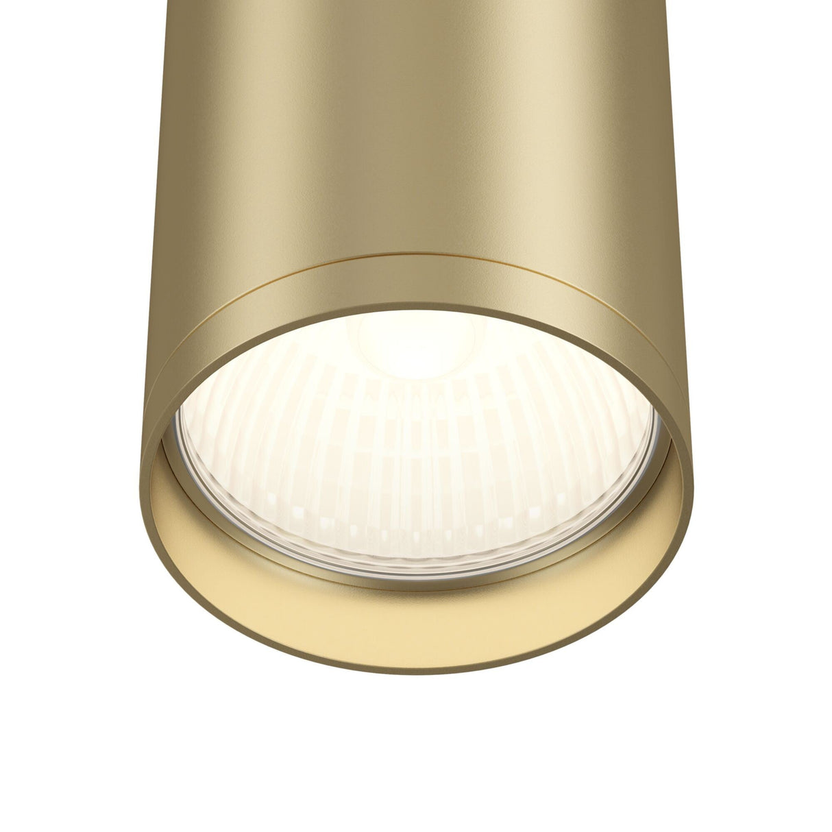 The Focus S Fixed Round Surface Mounted Downlight in matte gold showcases a cylindrical design with a visible round LED bulb, casting bright white directional light and highlighting its smooth metallic finish.