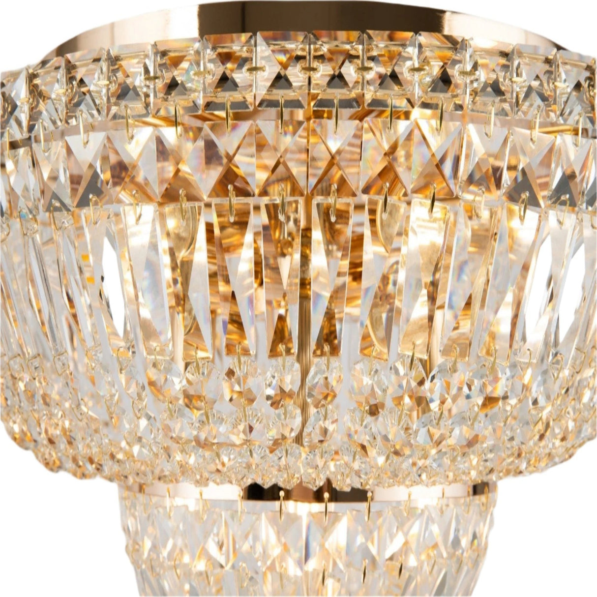 A close-up of the Basfor 12 Light Crystal Chandelier in gold showcases its ornate design, featuring diamond-cut glass prisms that create a luxurious, sparkling effect as they reflect warm light.