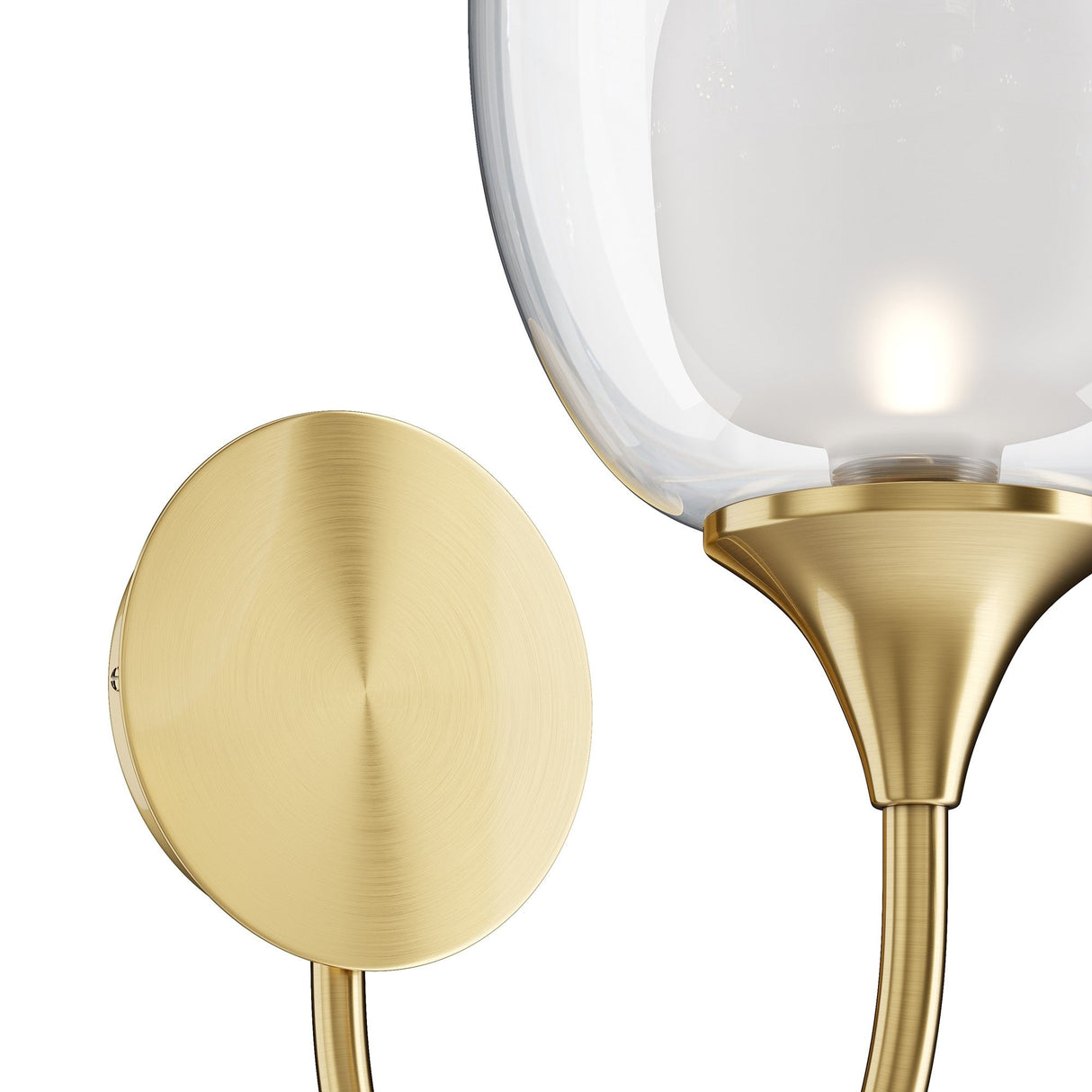 Close-up of the Aura Wall Light - Brass, showcasing a brass sconce with a round base and curved arm. It features a double-blown glass lampshade, softly illuminating to add warmth and elegance.