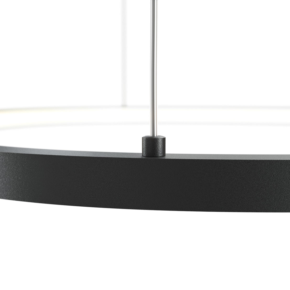 Close-up of a black Glint LED Circular Suspension Light 60cm on a white background. Suspended from a thin metallic rod, it showcases its energy-efficient, modern design with only part of the smooth-finish circular fixture visible.
