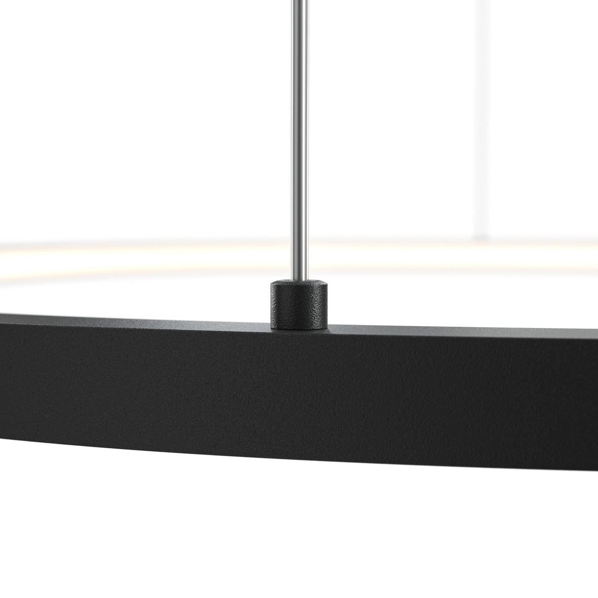 Close-up of the modern Glint LED Circular Suspension Light 80cm - Black featuring a circular design. A thin rod supports this minimalist pendant, allowing for adjustable height, highlighting the black metals texture and central rod attachment.