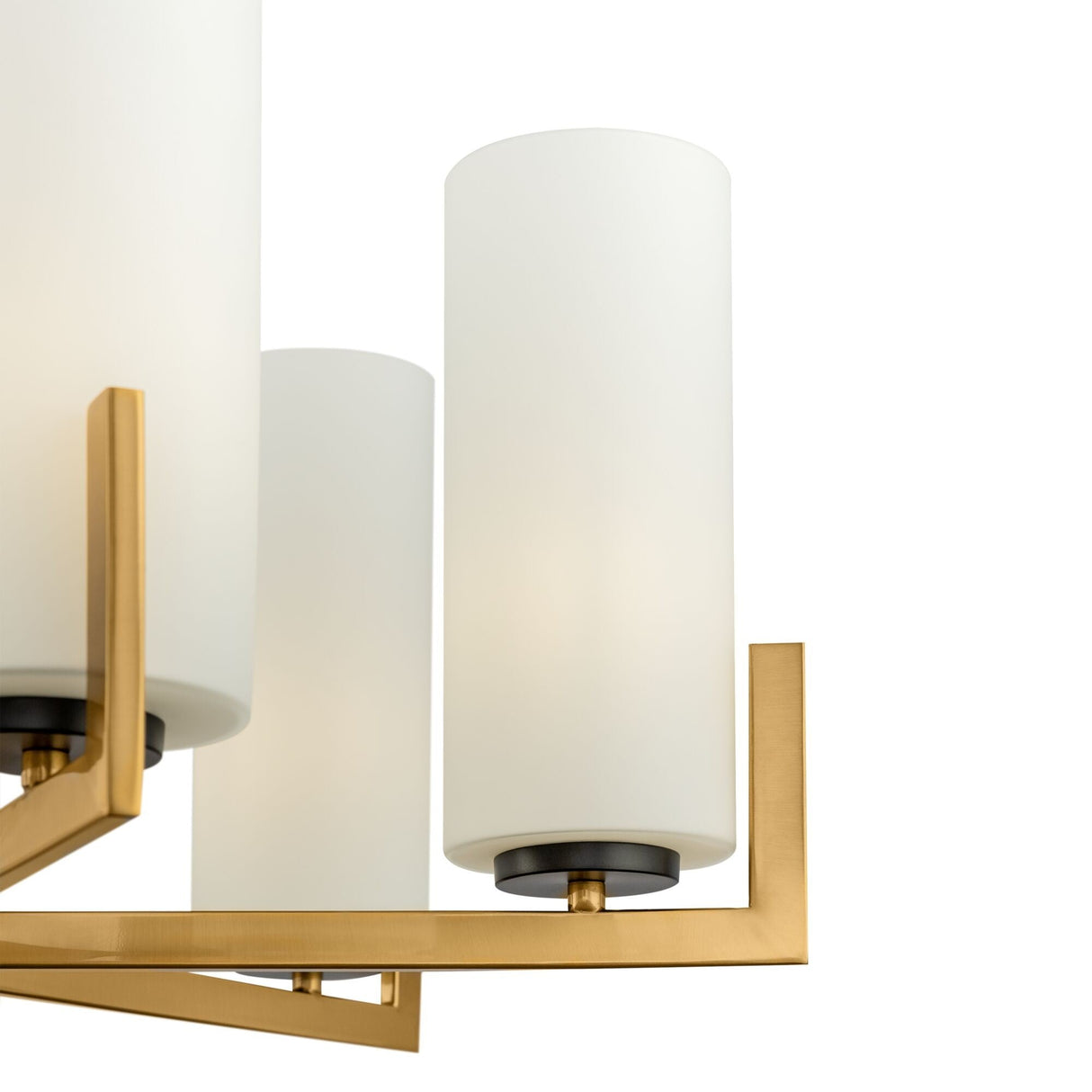 Close-up of the Fortano 6 Light Chandelier - Brass, featuring cylindrical white glass shades and brushed brass accents. This sleek, minimalistic design shows two visible light fixtures against a plain white background.