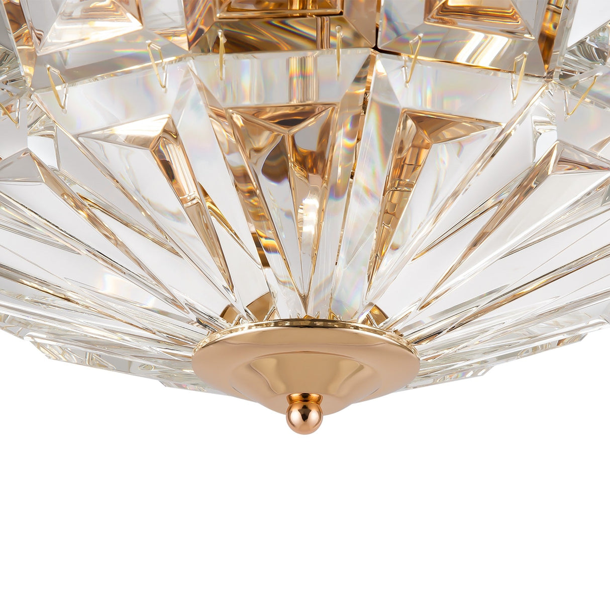 Close-up of the Facet 4 Light Flush - Gold & Crystal. It features a geometric, faceted glass design in a gold-toned frame with a central gold knob. The light reflects through the crystal, creating an elegant, shimmering effect like a luxury chandelier.