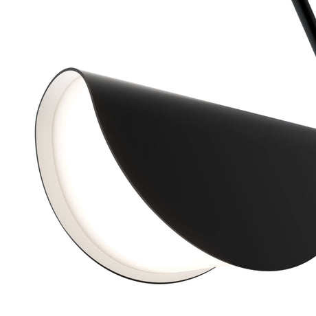 Close-up of the Mollis Curved Pendant Light - Black & White, a minimalist lamp with a smooth, curved design. Its black outer shell and soft white interior create a modern monochromatic look, resembling a folded arc or crescent ideal for ambient lighting.