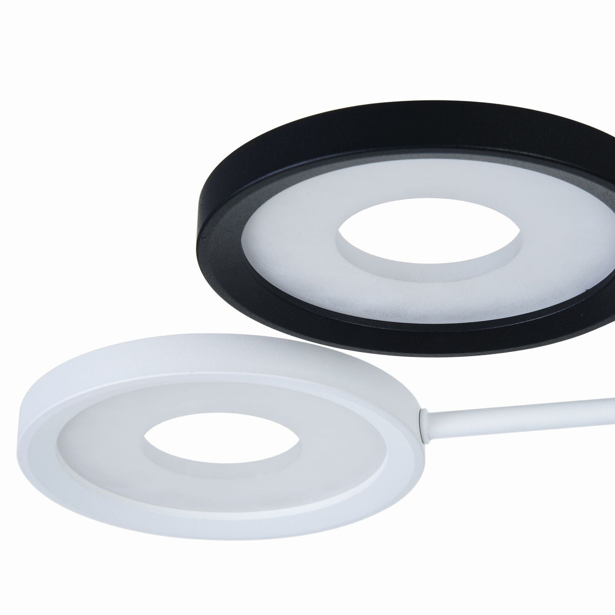 The Aprilia LED Ceiling Light in black and white features an ultramodern design with hollow centers. Positioned diagonally against a plain background, the energy-efficient lights include a partially stand-attached white light.