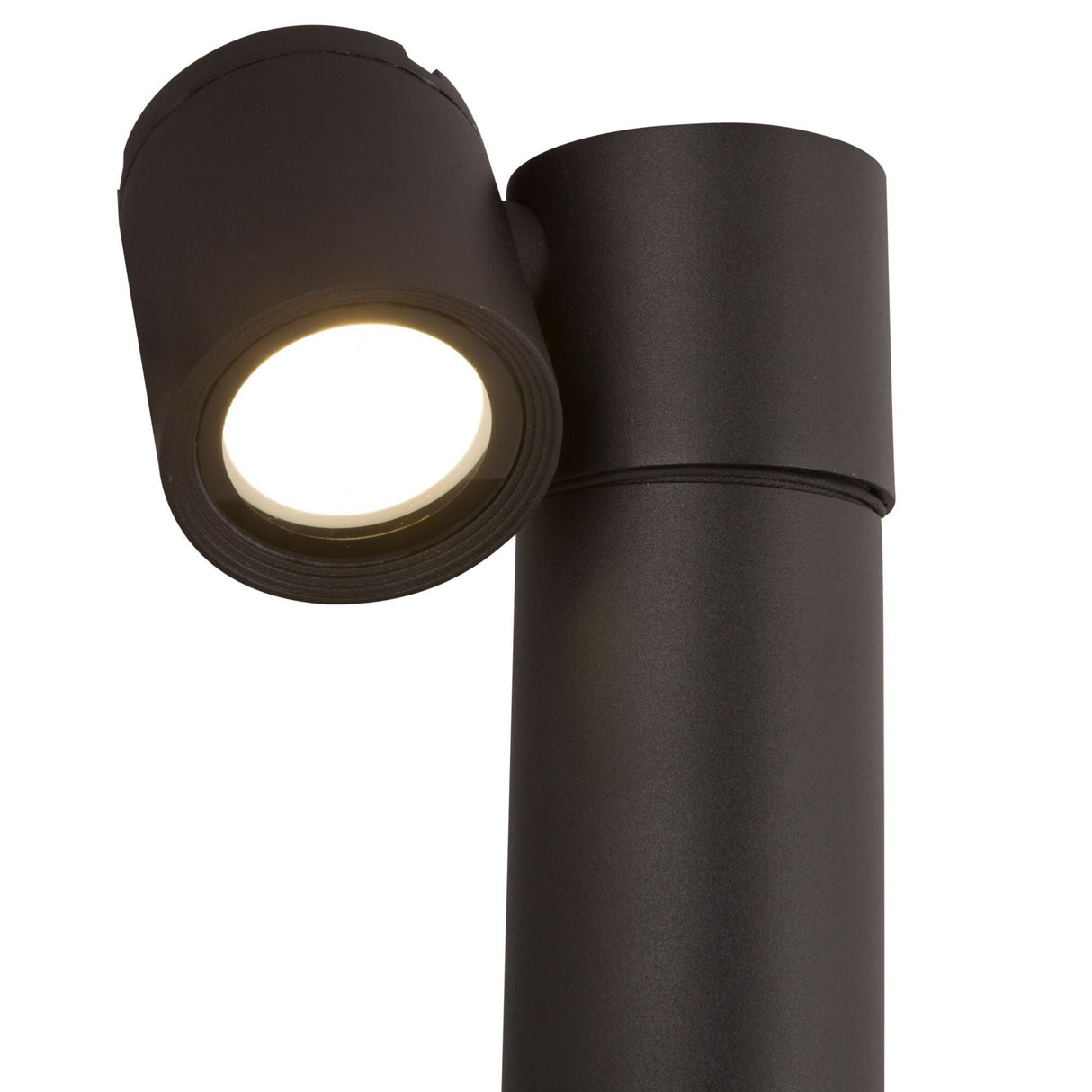 Close-up of the Wall Street 1 Light Bollard 55cm in black, featuring a modern cylindrical design. The fixture is mounted near the top of a tall black pole, casting a soft white glow.