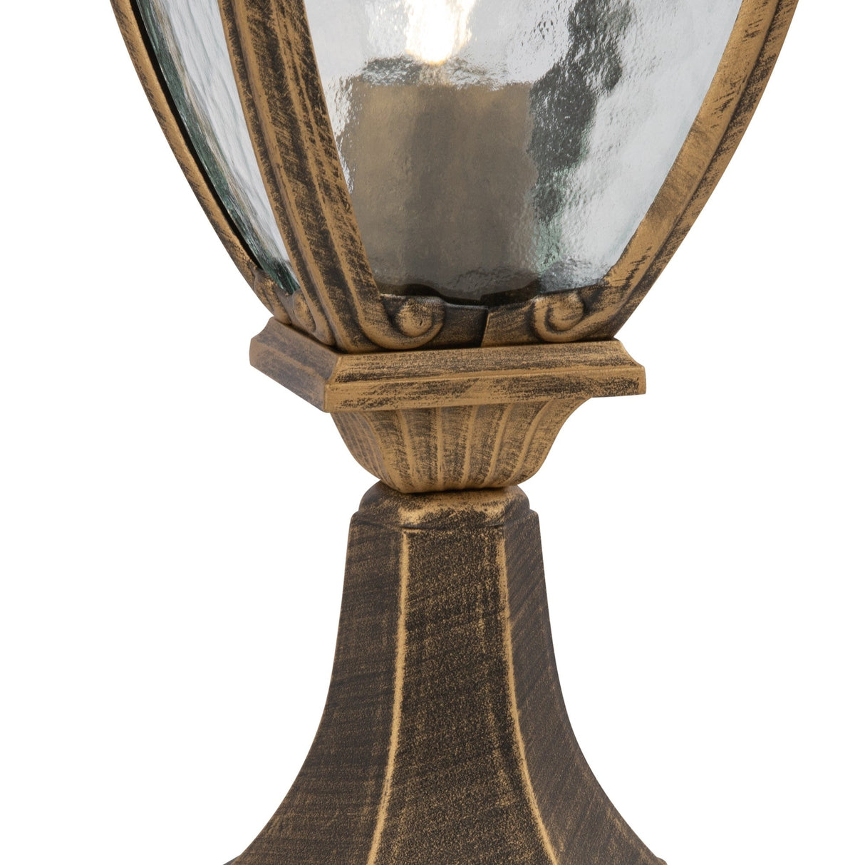The Fleur Pedestal Light - Black showcases a vintage-style lamp post with a traditional lantern shape, featuring decorative PULEGOSO glass in a textured enclosure and ornate detailing at the base. Its weathered bronze finish adds antique charm to this outdoor lighting piece.