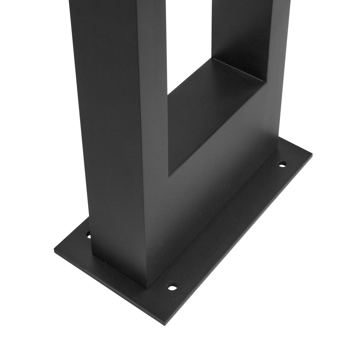 A close-up of a black metal table base showcases a rectangular shape with a flat bottom plate featuring four mounting holes. The modern, minimalist design with clean edges complements the sleek style of the Bonn Bollard Light 100cm - Graphite perfectly.