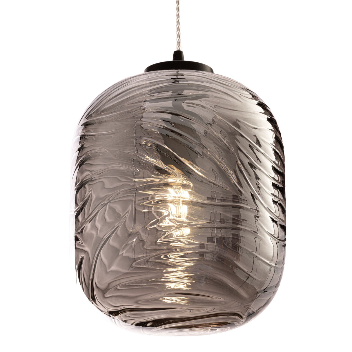 The Dunas Oblong Pendant Light - Black with Smoked Patterned Glass casts a warm glow, enhancing its swirling patterns. Its contemporary design and stylish cord make it perfect for modern spaces.