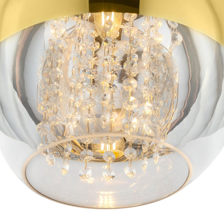 A close-up of the Fermi Large Dome Pendant Light shows its glass cover, adorned with hanging crystal-like beads around a central bulb. The gold and clear glass with crystal accentuates modern sophistication and elegance.