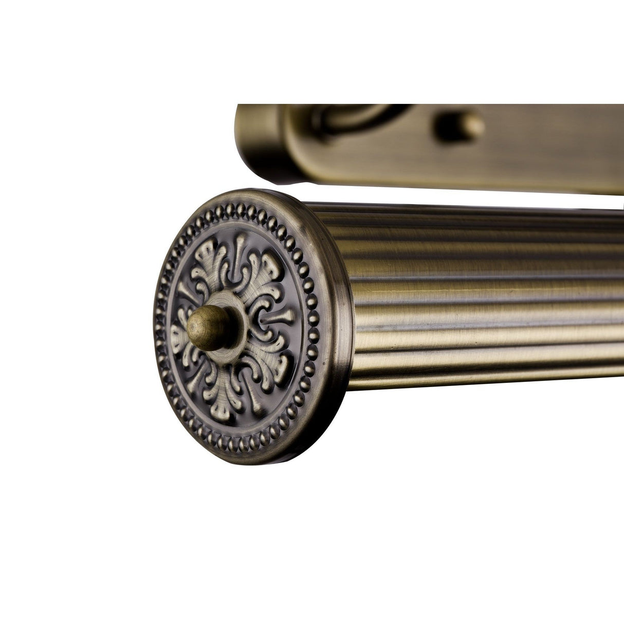 A close-up of an antique-style brass curtain rod showcases intricate circular floral detailing at the end cap. The rod has horizontal grooves and a warm, aged bronze finish reminiscent of a Govanni Ribbed Picture Light - Bronze, highlighted against a plain white background.