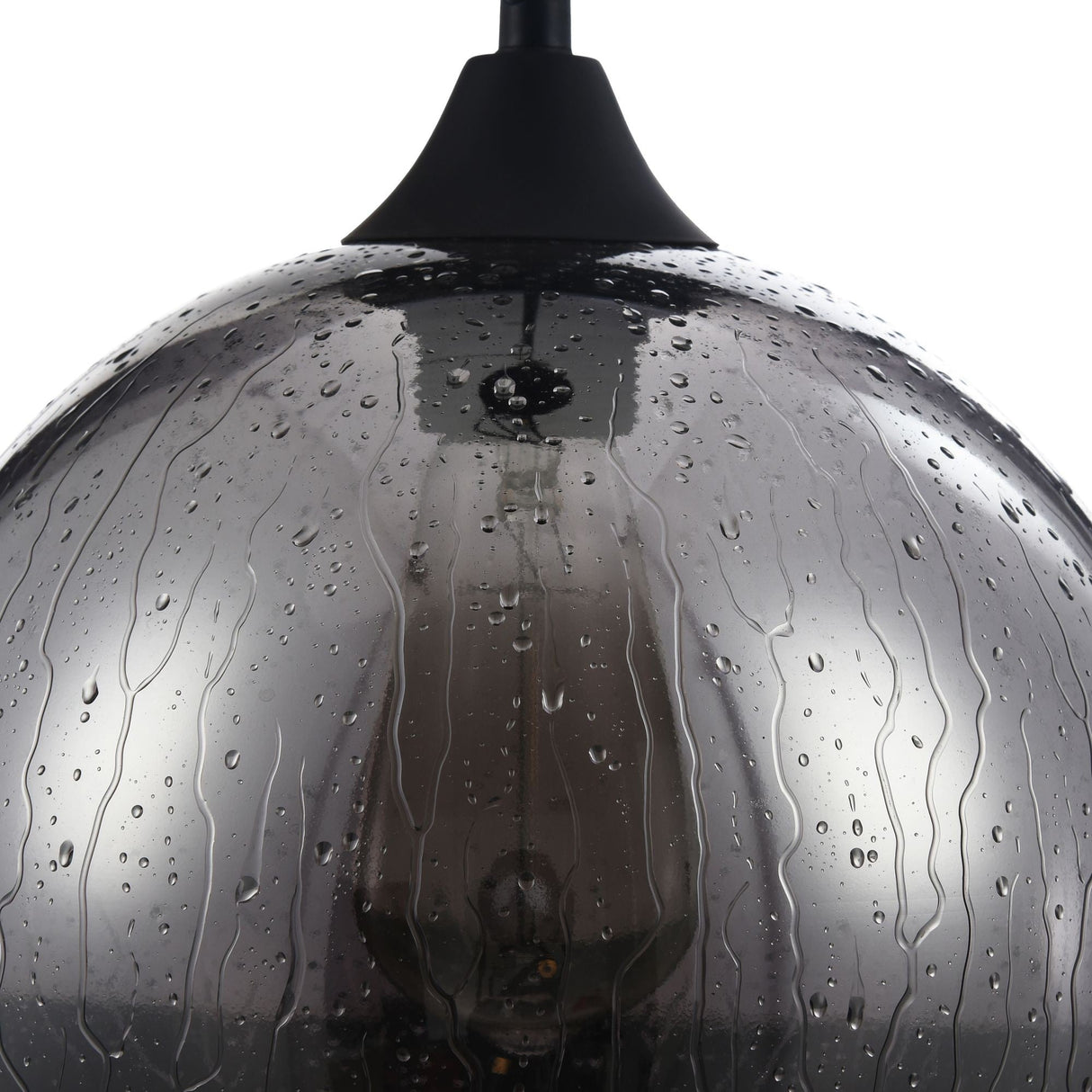Close-up of the Bergen Pendant Light, showcasing its round matte smoky glass shade with rain jets effect. The internal bulb glows through the textured glass, and the top offers modern elegance with its matte black finish.