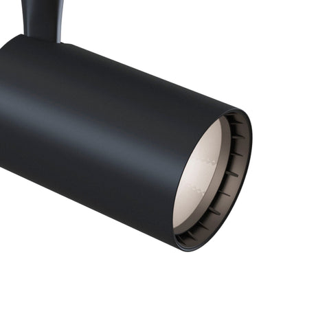 The Vuoro LED Single Phase Unity Track Spotlight 6W 3000K - Black features a sleek, modern cylindrical design with a smooth matte finish and ridged inner edge. Perfect for accent lighting, its energy efficiency supports sustainable living.