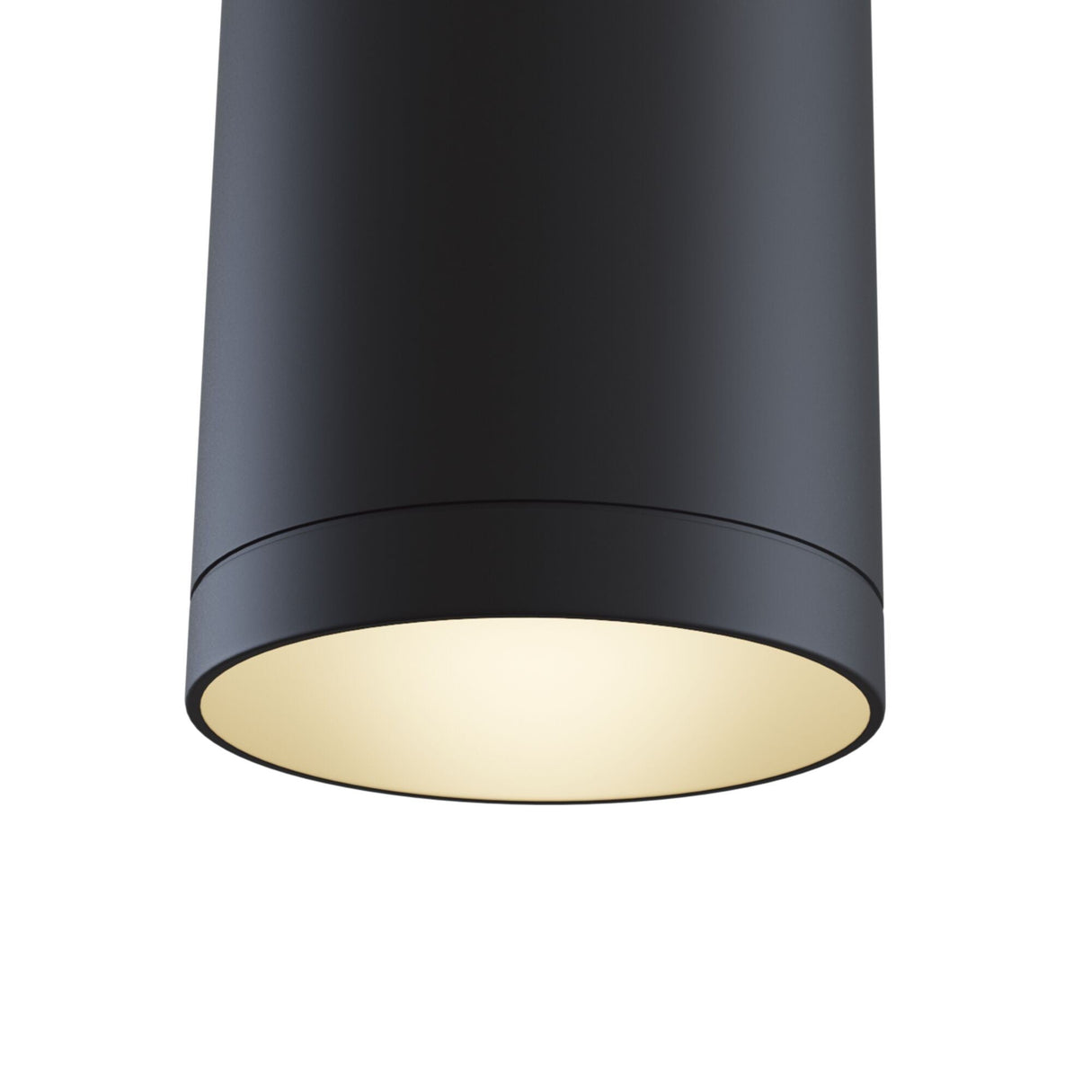 Heres a close-up view of the Single Phase UNITY Track Pendant Light in black, featuring a sleek cylindrical design with a smooth finish, exuding a warm, soft glow like that of a modern industrial light.