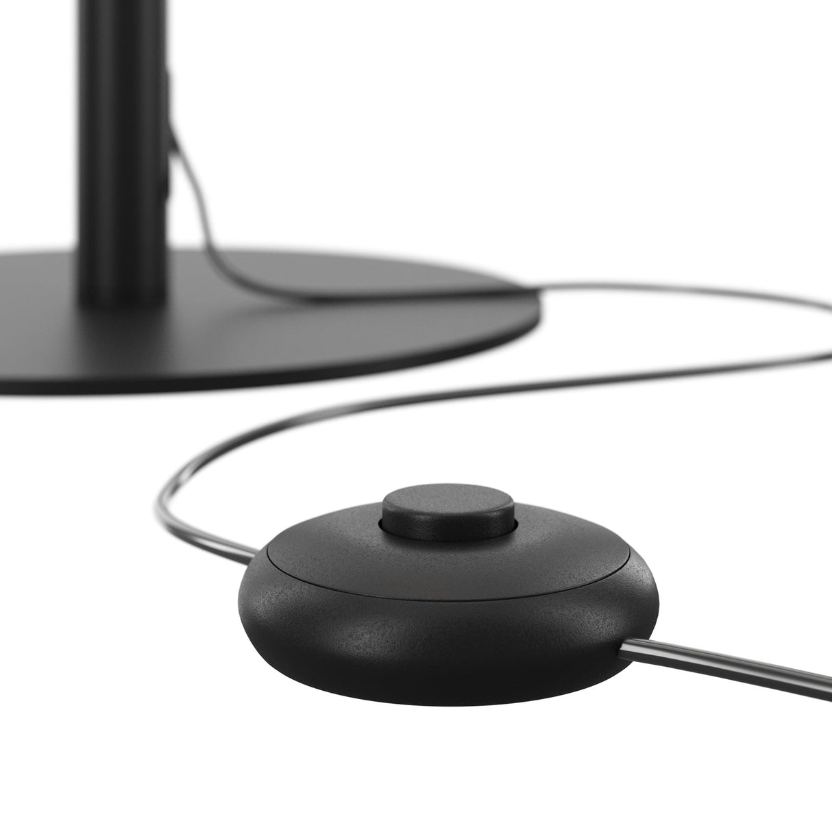 The Ray LED Floor Lamp - Black features a black circular footswitch with a central button. Its sleek design includes a round base and vertical pole, offering minimalist lighting on light surfaces for energy-efficient illumination.