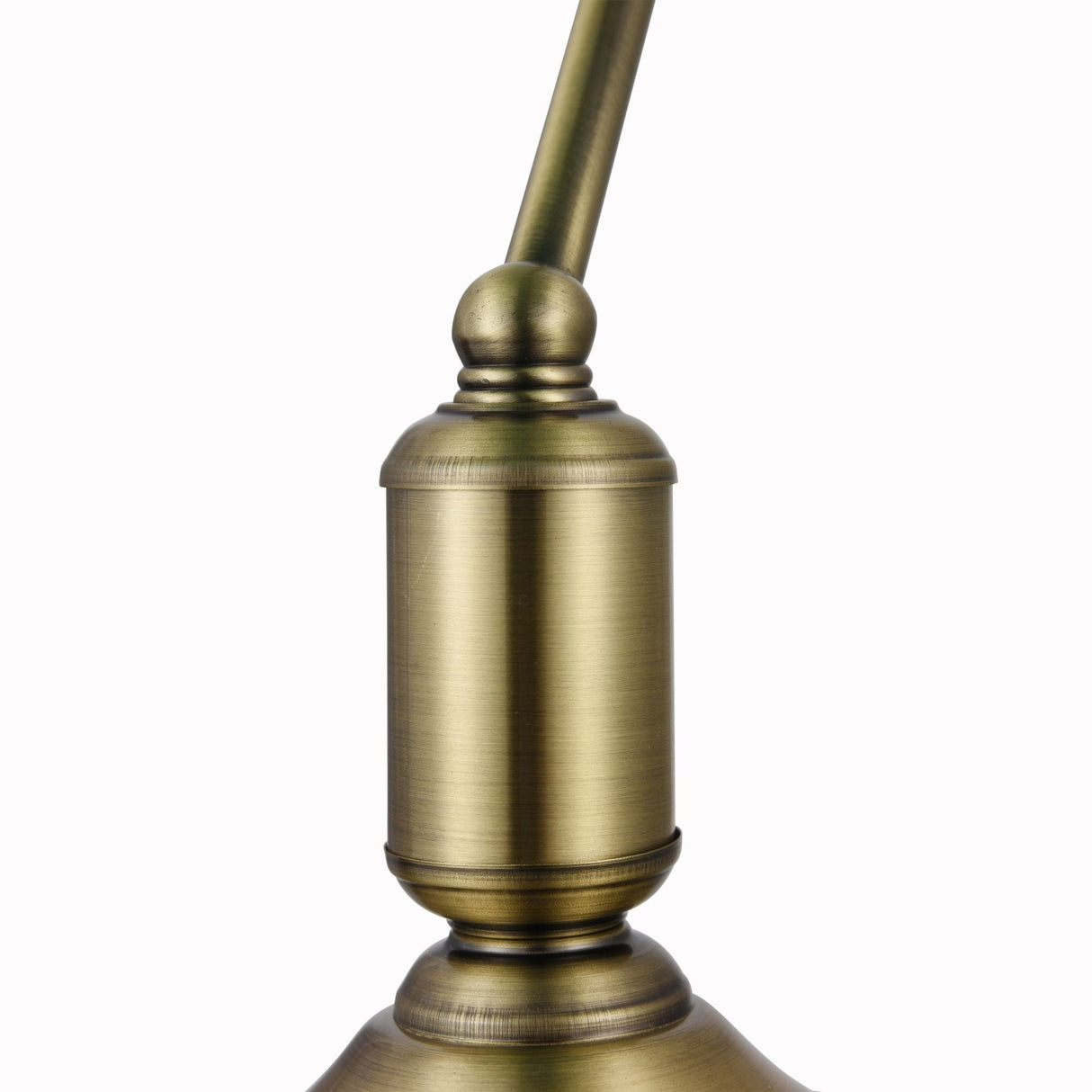 Close-up of the Kiwi Table Lamp in antique brass, showcasing vintage charm with a cylindrical design and decorative round finial. A curved arm supports a green glass shade, while the brushed finish enhances its timeless appeal.