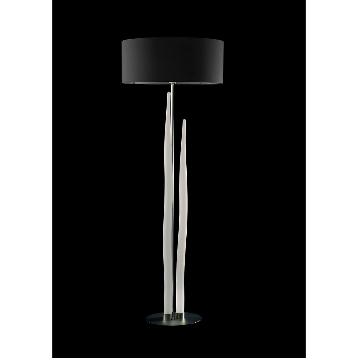 The Estalacta 3 Light Floor Lamp features a round black shade, three tall slender white sculpted rods as the base, and a circular silver stand—an eye-catching modern piece ideal for contemporary interiors.