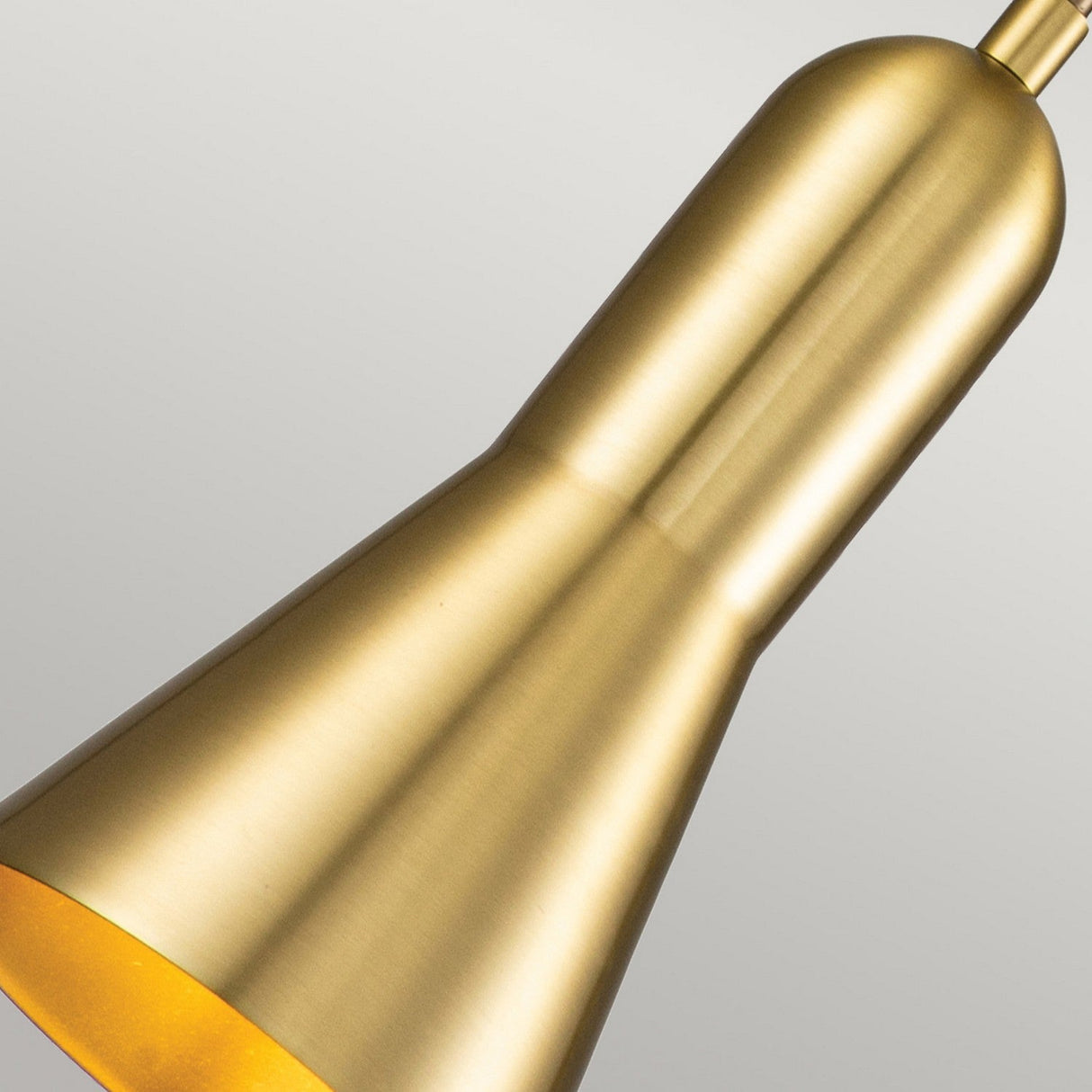 A close-up of the Etoile 1 Light Small Pendant Light in aged brass, featuring a smooth metallic finish and an adjustable black cord. The light is off, set against a plain gray background.