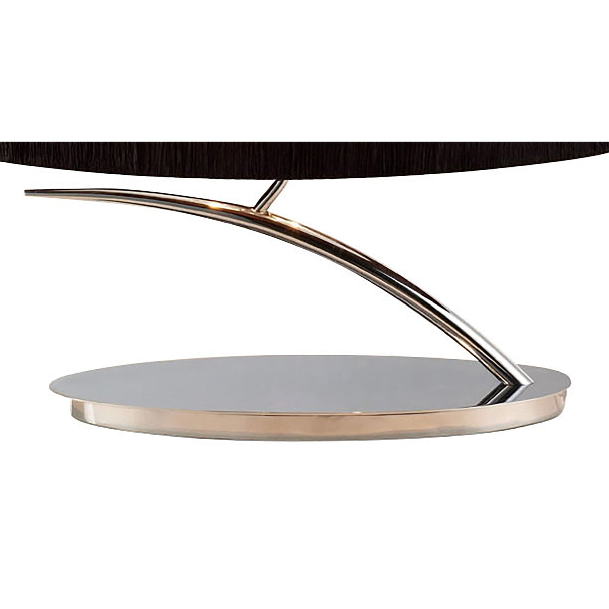 Close-up of a modern furniture base with a shiny circular platform and curved support, echoing the sleek look of the Eve 2 Light Table Lamp - Polished Chrome With Black Oval Shade and its reflective, contemporary style.