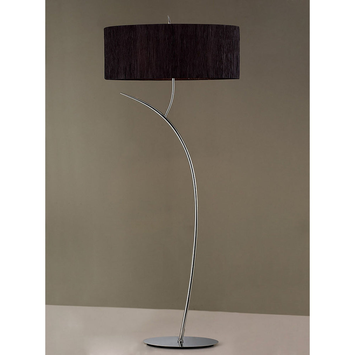 The Eve 2 Light Floor Lamp features a modern chrome design with a curved stem, black oval shade, and flat circular base—an elegant contemporary lighting piece for any space.
