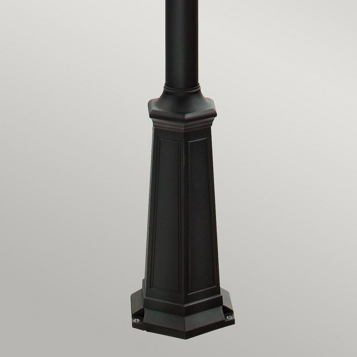 A close-up view of the Firenze 3 Light Lamp Post in black, featuring a hexagonal base with decorative panels and a sleek black finish, ideal for enhancing an outdoor space against a light gray background.