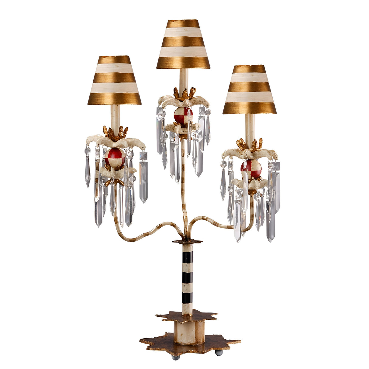 Introducing the Birdland 3 Arm Table Lamp - Cream & Gold, featuring a whimsical and artistic candelabra-style design. This decorative lamp comes with striped gold and white shades, accented by hanging K9 cut glass clusters and ornate red details. The lamp elegantly blends metal and crystal elements to create an eye-catching piece.