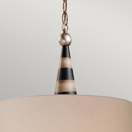 A close-up of the Flambeau 2 Light Pendant highlights its contemporary design, showcasing a conical, striped pattern in black and cream. Hanging from a metal chain, the shade exudes a smooth, light cream color with hints of gold leaf, effortlessly complementing various interior styles.