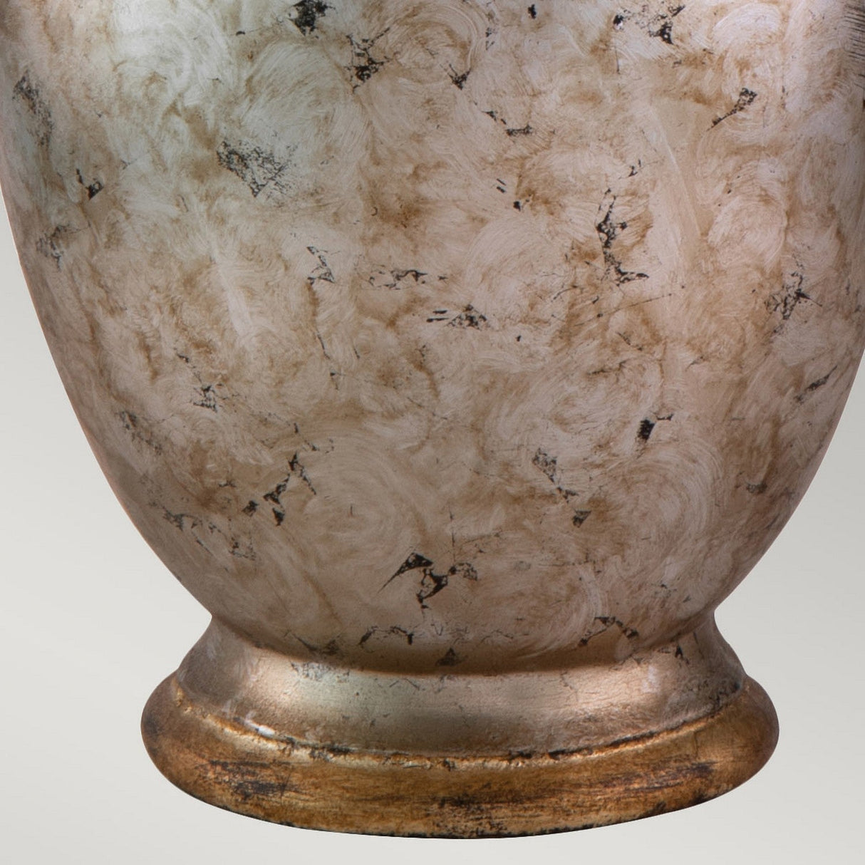 Close-up of the Jackson 1 Light Table Lamp in antiqued silver with a gold leaf design, featuring a textured surface that mimics a beige ceramic vase with marbled patterns. Its rounded base and mix of light brown and cream shades create a rustic yet sophisticated appearance.