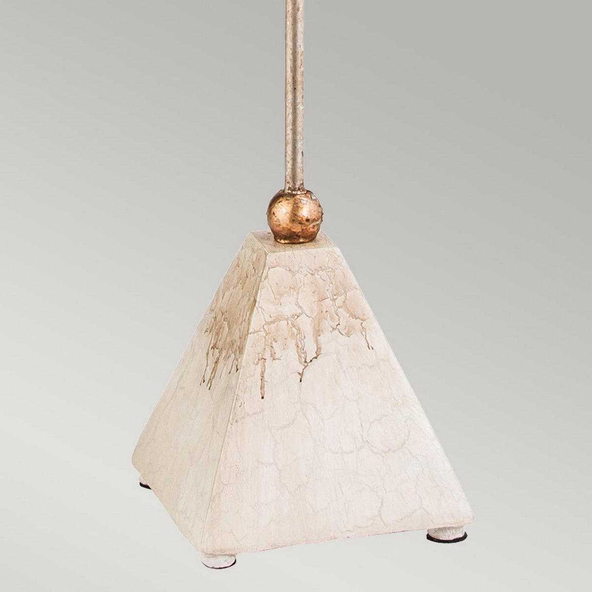 The Madison 1 Light Table Lamp features an elegant design with a pyramid-shaped base in a crackled cream texture, highlighted by a small brass sphere. Its subtle putty patina beautifully complements the neutral gray background, enhancing its sophisticated allure.