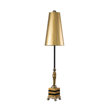 The Noma Luxe 1 Light Table Lamp in gold, black, and silver leaf features a vintage design with a gold-leaf conical shade and black stem adorned with a decorative figure. It sits on a square, striped base with metallic accents, offering an elegant touch against the plain white background.