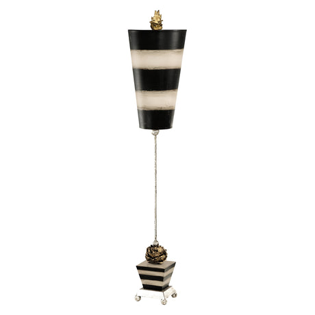 The Peony 1 Light Table Lamp showcases a tall, abstract design decorated with black and taupe stripes. It features a narrow top and broader base, accented by small golden details at both ends connected by a slender vertical rod. This elegant piece stands on a silver leaf-finished four-legged platform.