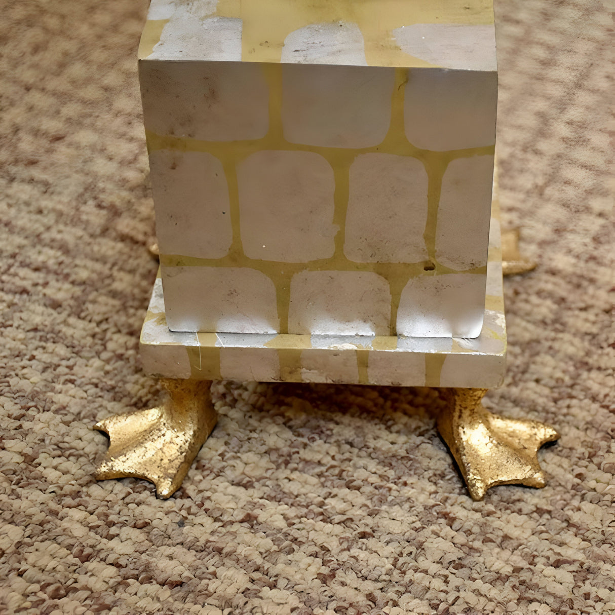 A Pompadour X 1 Light Table Lamp in cream with a silver leaf base stands atop four golden duck feet, placed on a speckled carpet.