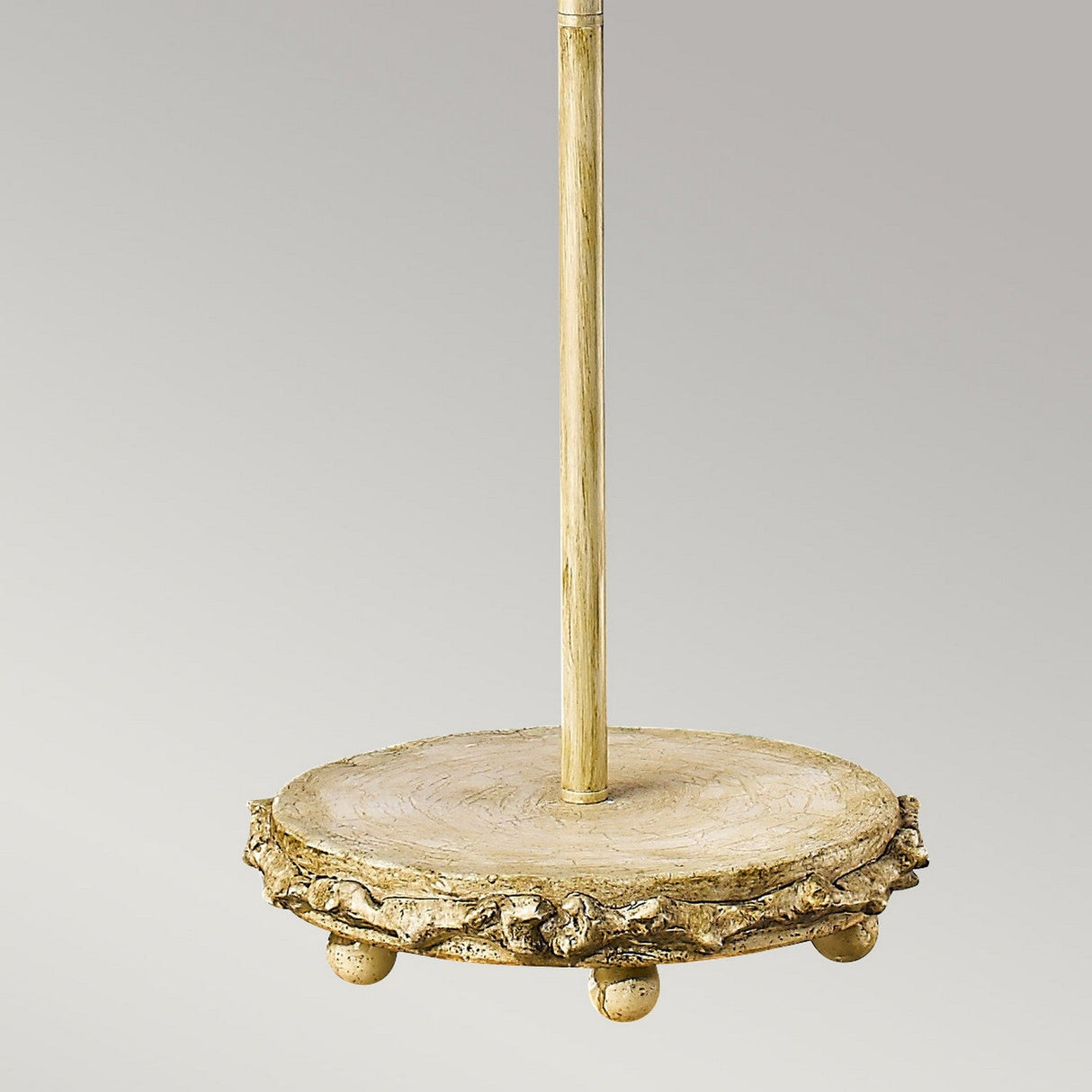 A rustic Trellis 1 Light Floor Lamp featuring a putty patina and silver leaf finish. The lamp showcases an artfully designed silhouette with hand-painted details to accentuate its natural charm, supported by a single vertical stand and four decorative feet. A light, artisanal finish enhances its handcrafted appearance.