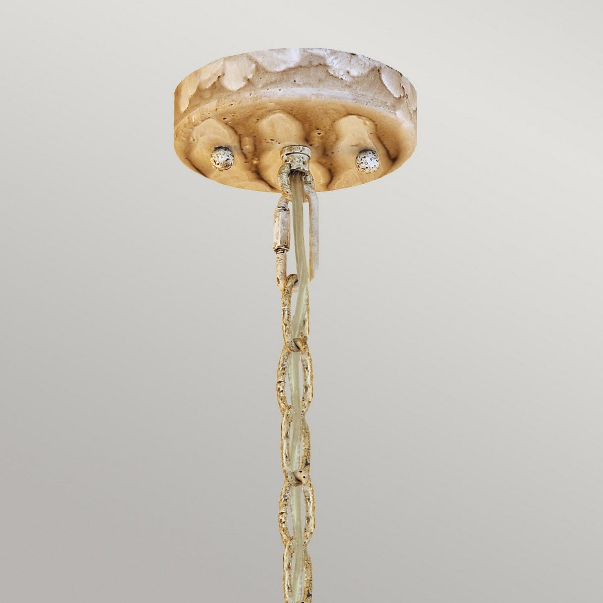 A textured, beige ceiling mount with a decorative chain features linked loops with a rust-like finish for a rustic touch. It resembles the Trellis 1 Light Pendant - Putty Patina & Silver Leaf, and the hand-painted putty patina finish adds elegance against the neutral gray background.