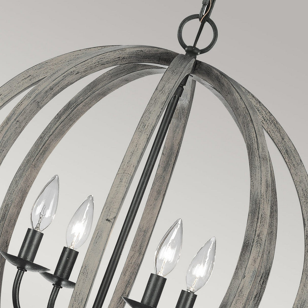 Introducing the Allier 4 Light Chandelier, intricately designed with a rustic industrial flair. This spherical chandelier showcases four exposed candle-style bulbs, complemented by a weathered oak wood finish and antique forged iron accents for that vintage charm. Elegantly suspended by a chain, it makes for a striking addition to any space.