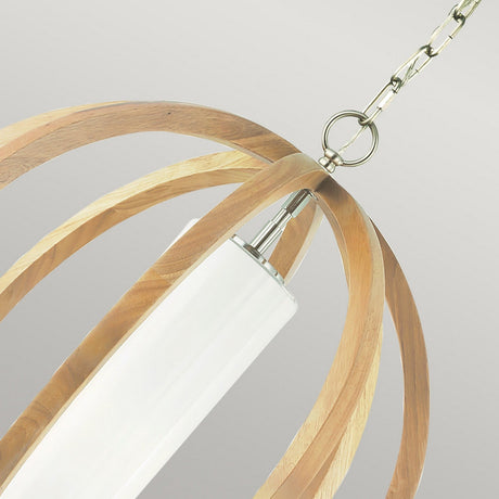 The Allier 1 Light Small Pendant in light wood and brushed steel showcases a contemporary rustic design, with a cylindrical white shade elegantly encased within a concentric wooden spherical frame. It hangs gracefully from a brushed steel chain against a neutral backdrop.
