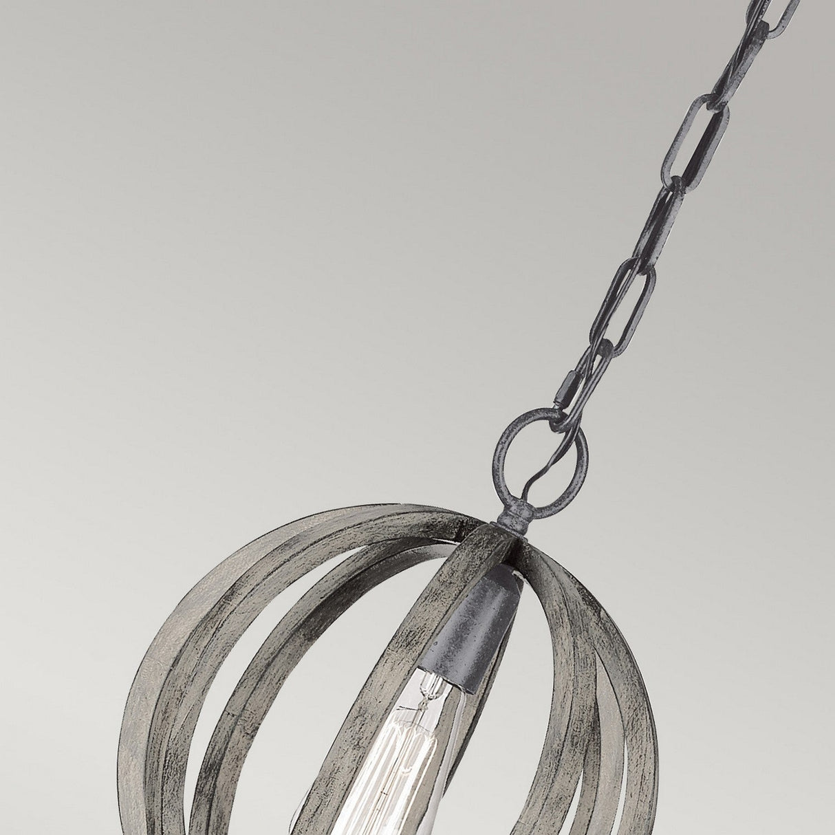 Close-up of the Allier 1 Light Mini Pendant, showcasing its weathered oak wood and antique forged iron circular frame with a visible bulb, suspended by a chain. The background is a plain, light gray color.