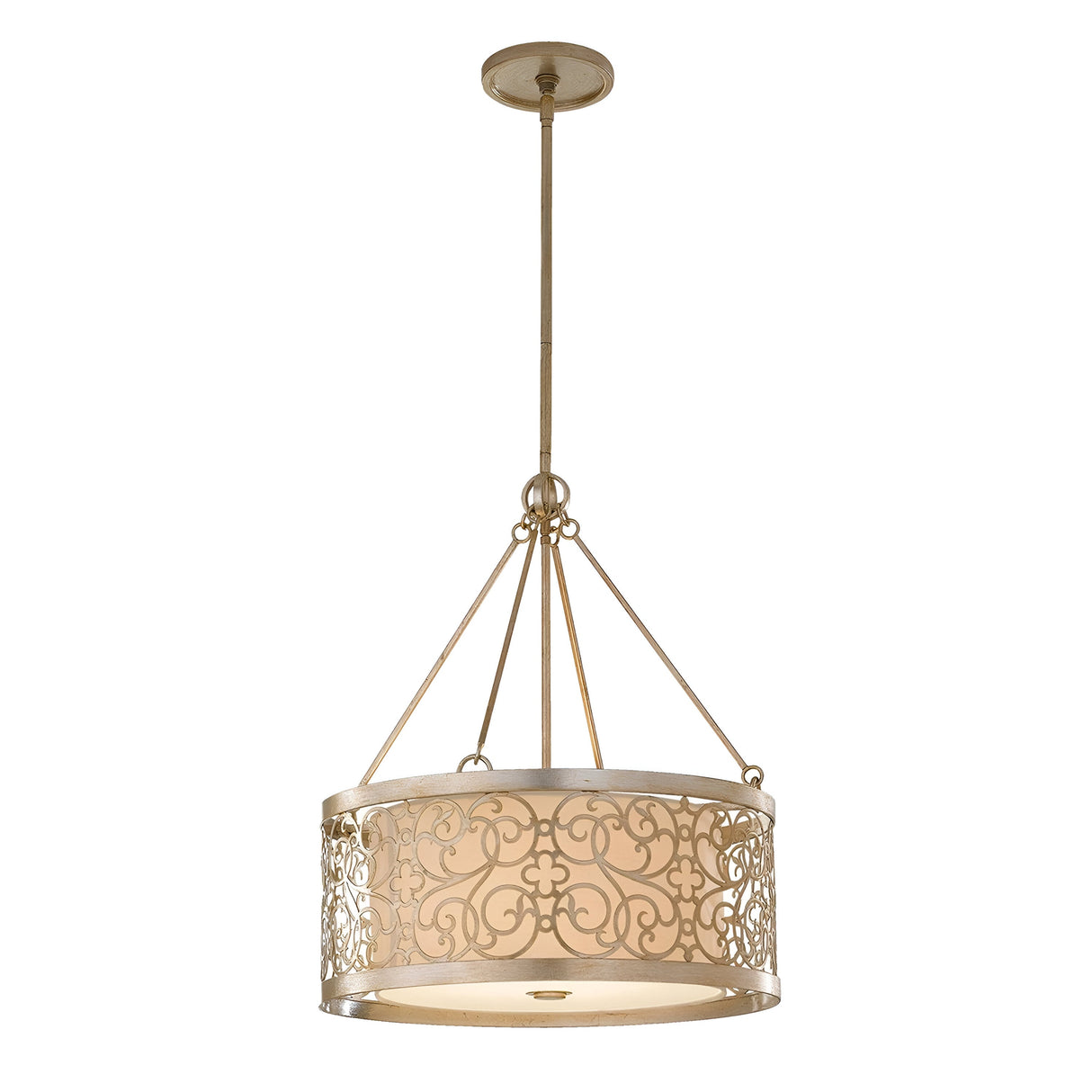 The Arabesque 4 Light Chandelier - Silver Leaf Patina hangs from the ceiling, showcasing an intricate circular metal frame with decorative scrollwork. The beige drum-shaped shade is complemented by a silver leaf patina finish and is suspended by four rods attached to a central fixture.