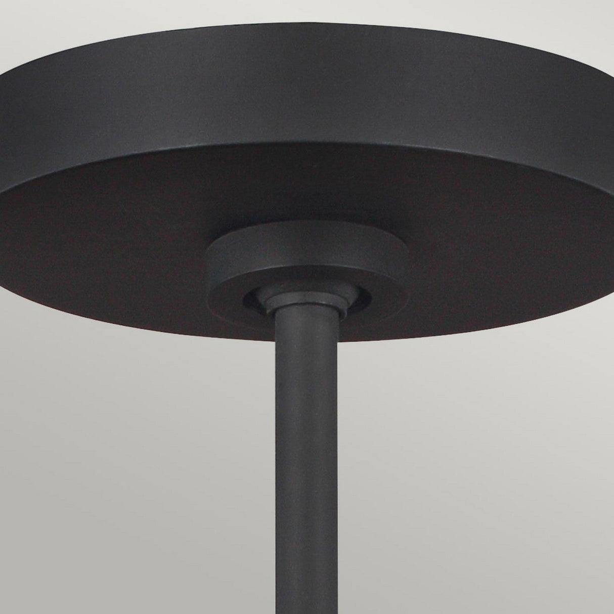 Close-up of the Asher 5 Light Pendant in Midnight Black & Gold, featuring a sleek cylindrical base and rod with an industrial-inspired design against a light gray background.