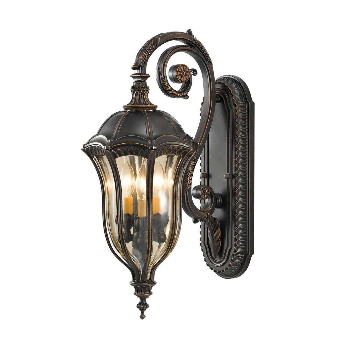 The Baton Rouge 3 Light Outdoor Medium Wall Lantern, featuring a vintage-style design, comes in a rich walnut finish with intricate detailing. It has a curved arm and clear glass panels showcasing three candle-like bulbs inside, evoking the timeless elegance of Baton Rouge's historic charm.
