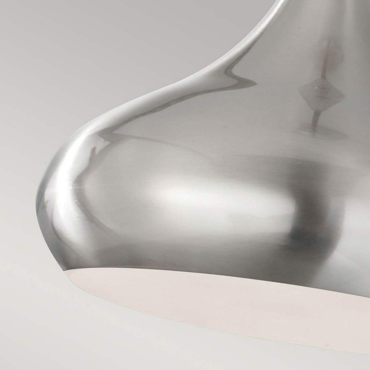 Close-up of the Beso 1 Light Medium Pendant in Brushed Steel, showcasing a sleek, reflective surface and an elegantly curved design against a light gray background.