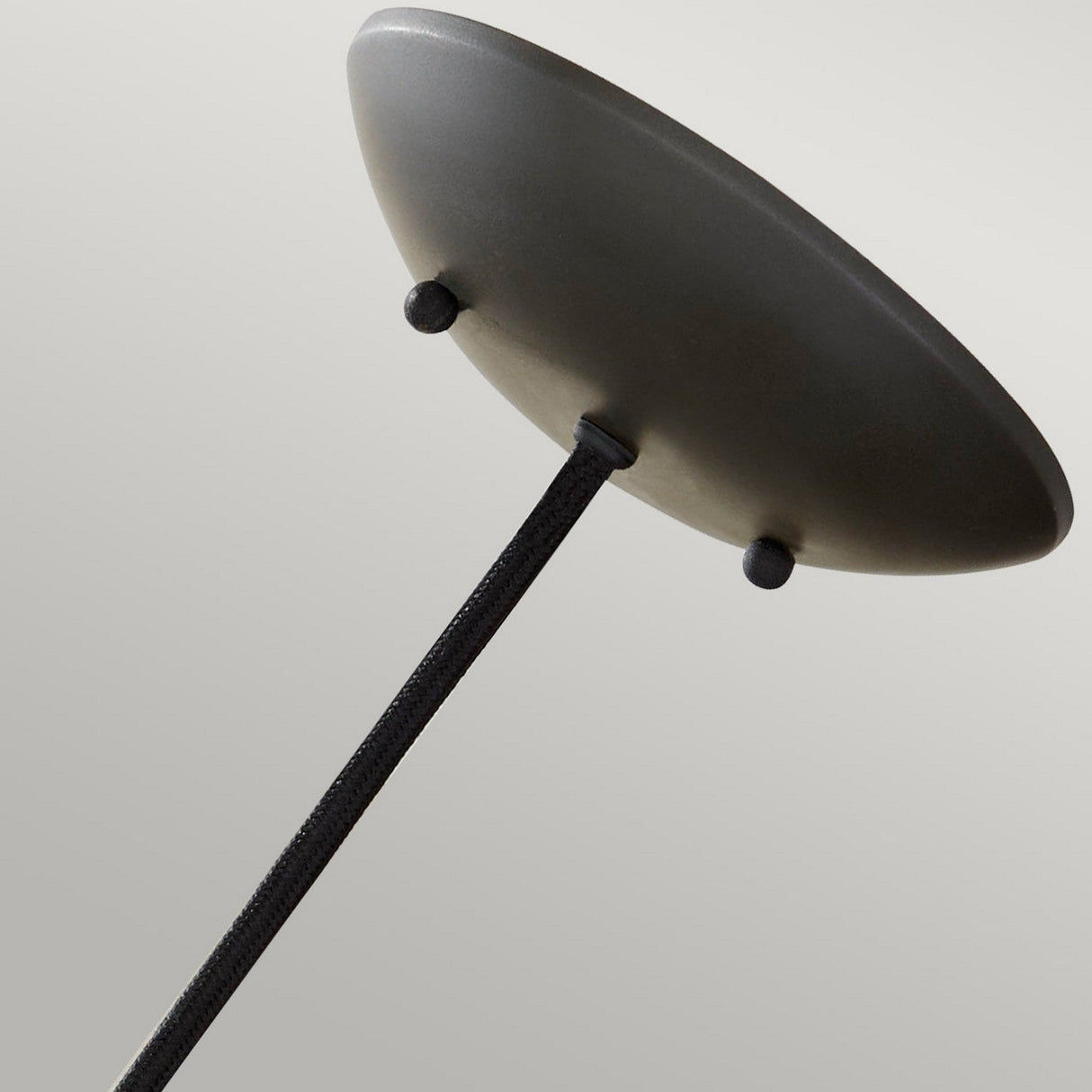 Elevate your contemporary space with the Beso 1 Light Medium Pendant in Dark Bronze. Featuring a minimalist design, this pendant showcases a round, flat canopy when viewed from below. Its slender stem extends vertically from the center, blending vintage sophistication with sleek modern elegance for a simple yet stylish aesthetic.
