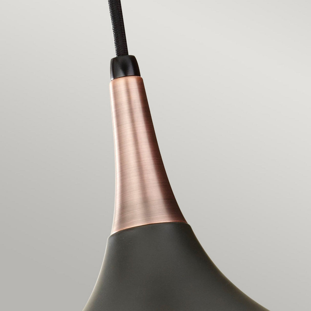 Close-up of the Beso 1 Light Medium Pendant featuring a dark bronze finish that exudes vintage sophistication. It showcases a sleek, tapered design suspended by a black cord against a neutral background, making it perfect for contemporary spaces.