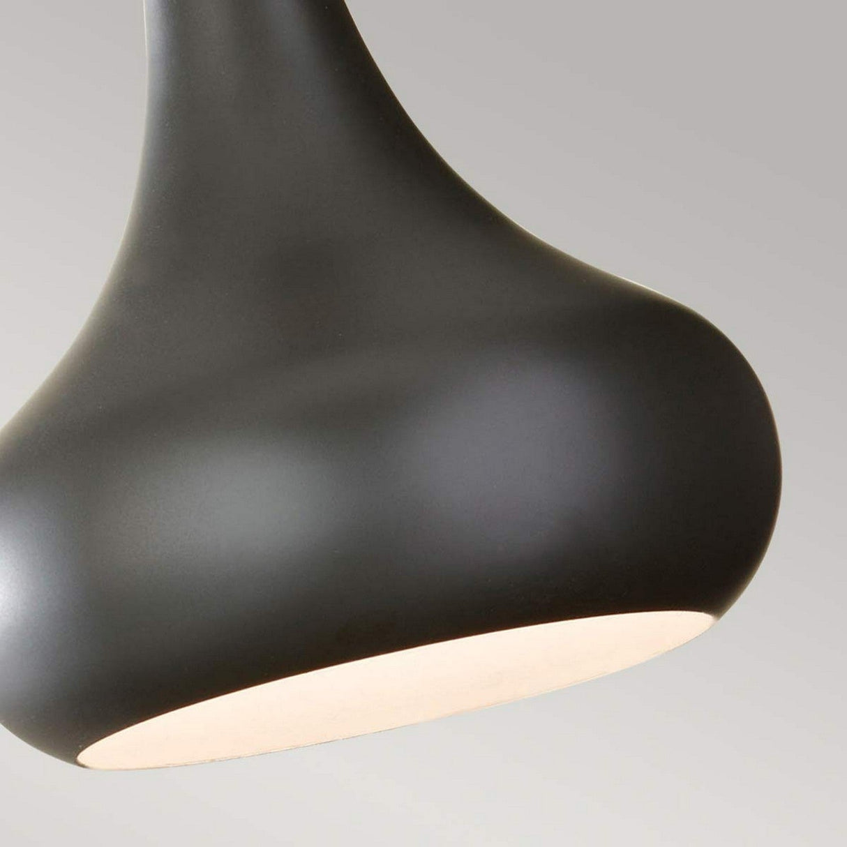 Close-up of the Beso 1 Light Mini Pendant in a dark bronze finish featuring a teardrop-shaped design. The smooth surface and darker hue stand out against a light gray background. This task lighting fixture's sleek and minimal appearance is enhanced by its hidden light source.