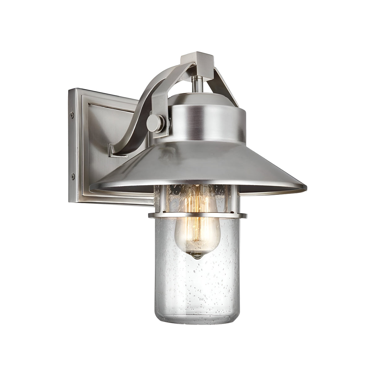 The Boynton 1 Light Outdoor Medium Wall Lantern - Painted Brushed Steel features a modern wall-mounted sconce design with a brushed metal finish and a clear glass cover. Its visible light bulb adds an industrial touch, while the weather-resistant lantern includes a rectangular backplate and is slightly angled downward.