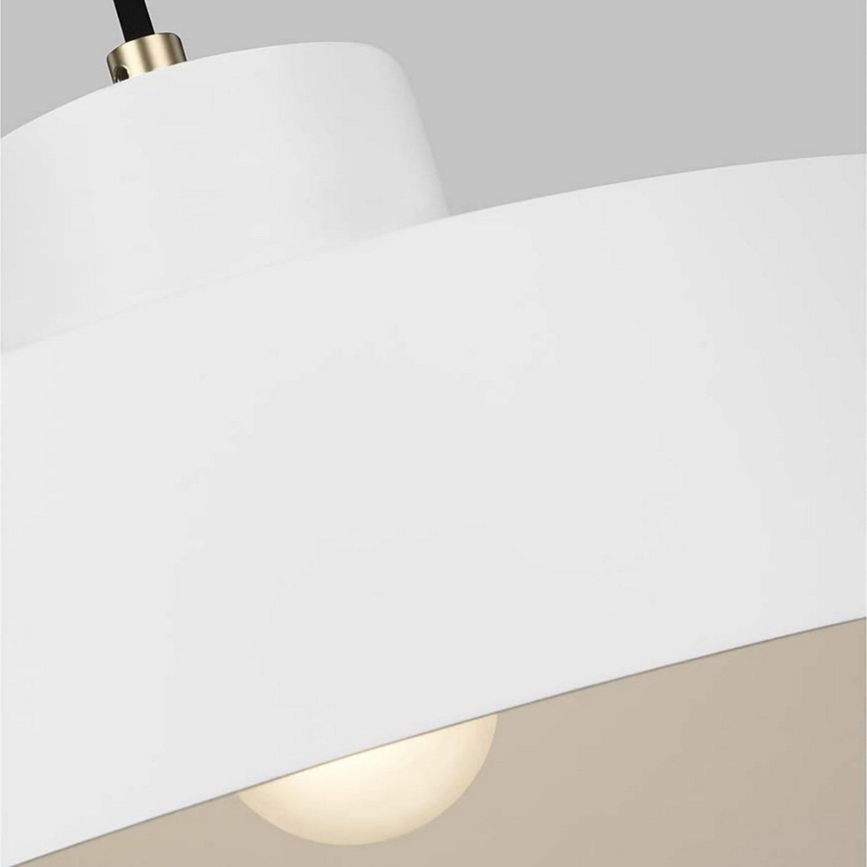 A close-up of the Candor 1 Light Pendant in a matte white finish highlights its modern vintage appeal, featuring a visible bulb. The smooth, curved design is complemented by brass accents and elegantly suspended from a black cord against a neutral gray background.