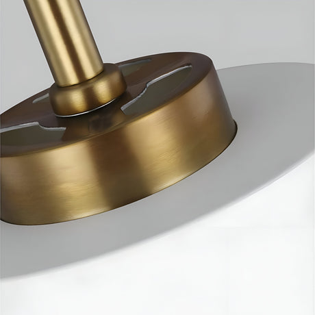 Close-up of the Carter 1 Light Pendant in matte white with brass accents, showcasing the base and part of the shade. The fixture, suspended from the ceiling, embodies simple yet elegant design elements perfect for contemporary interiors.